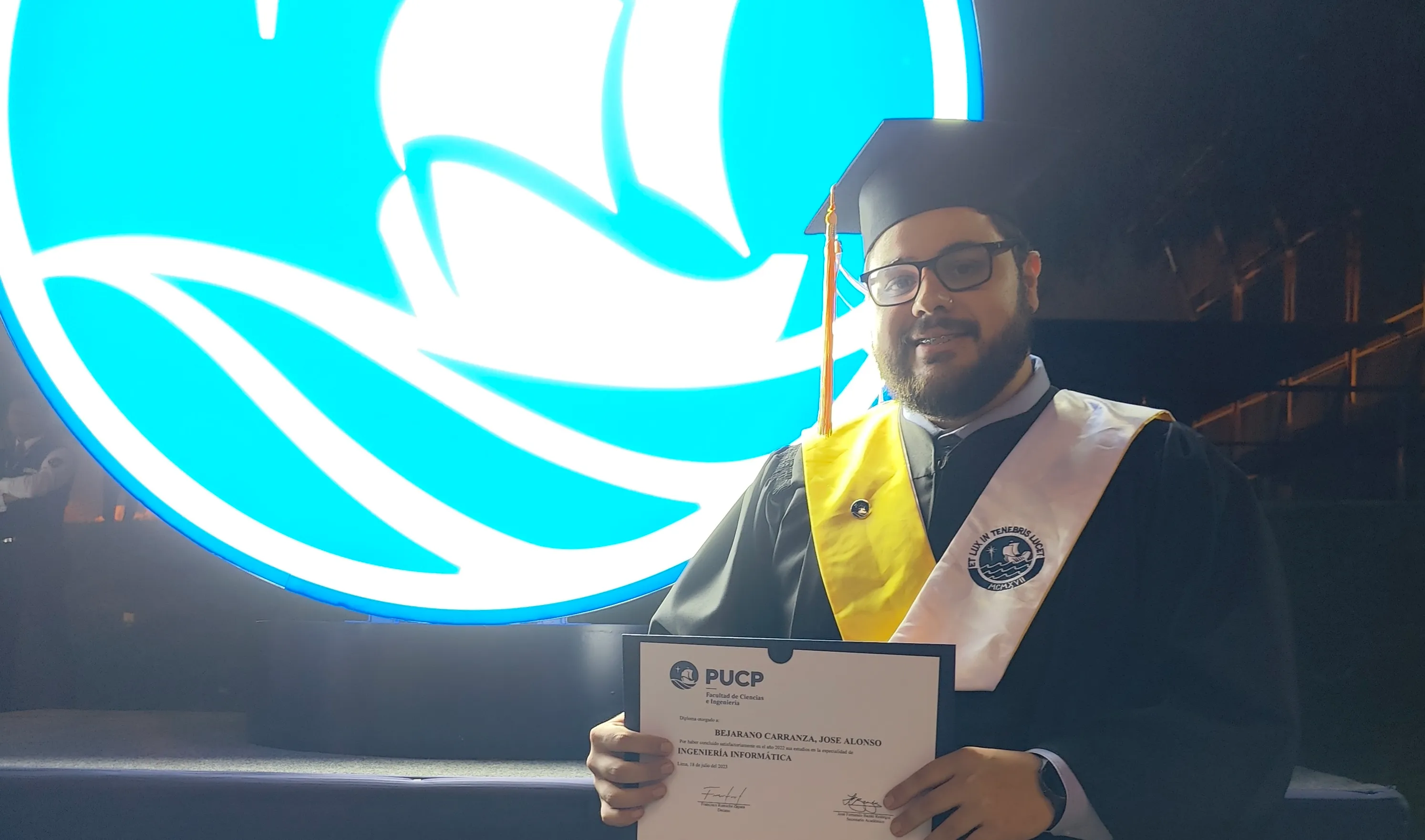 Jose Bejarano at his graduation, holding his engineering diploma